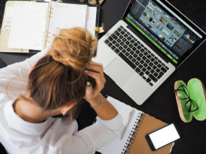 Frustrated women with cluttered desk